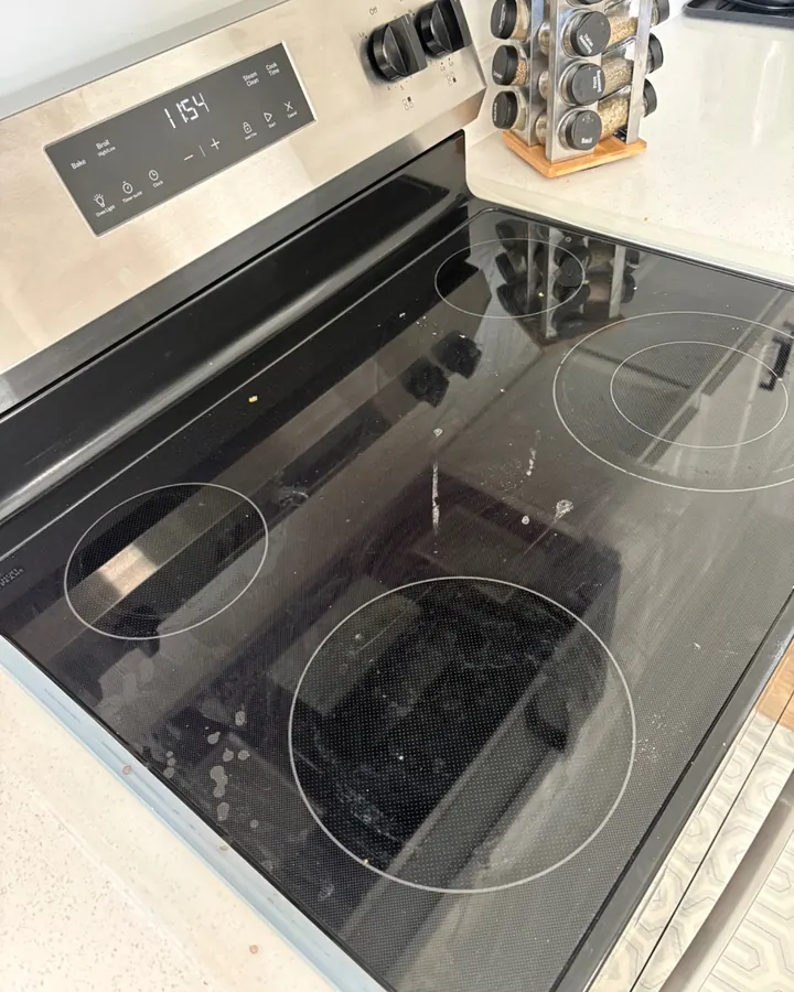 Before: a glass stovetop with smears and burnt-on rings.