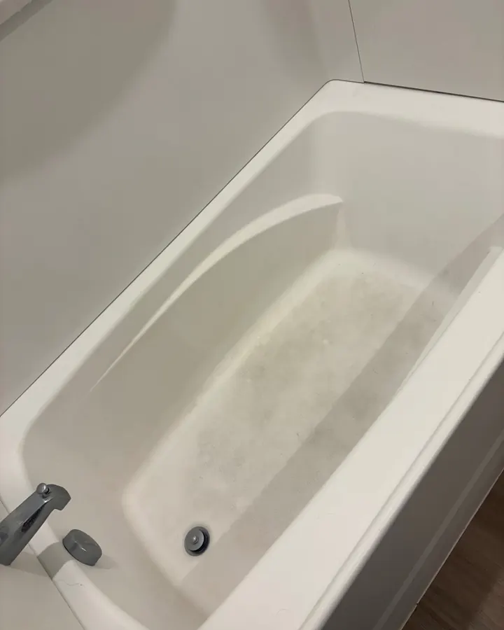 Before: a white tub with a grey film across the bottom.