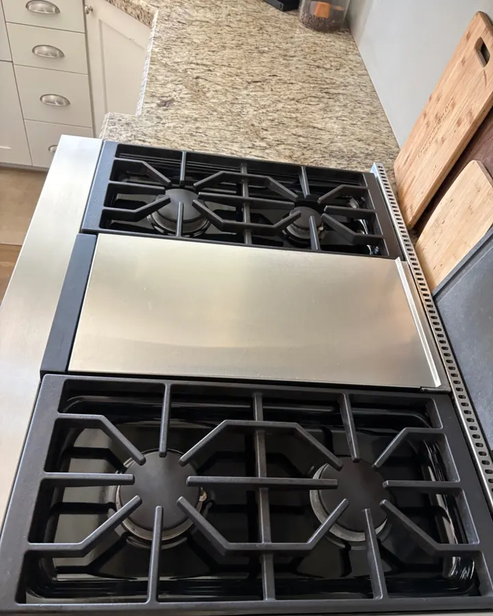 After: the same stove with clean grates and steel.
