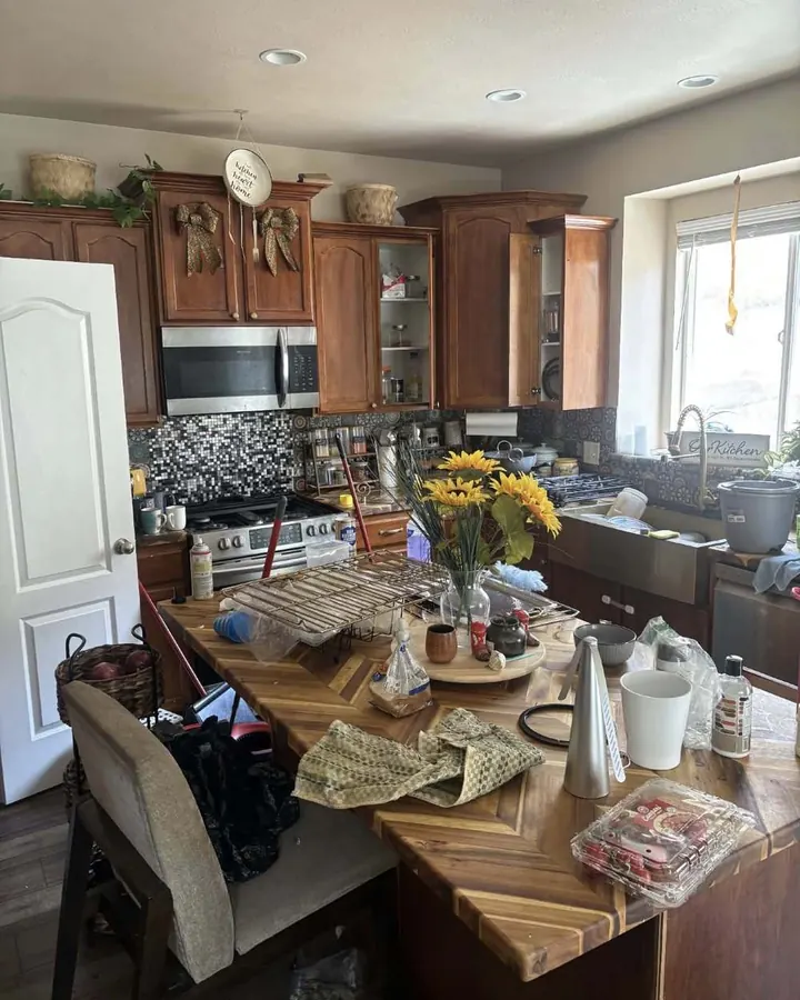 Before: a kitchen island covered in clutter.