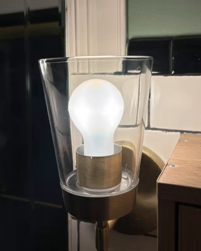 After: the same glass shade clear and the brass base polished.