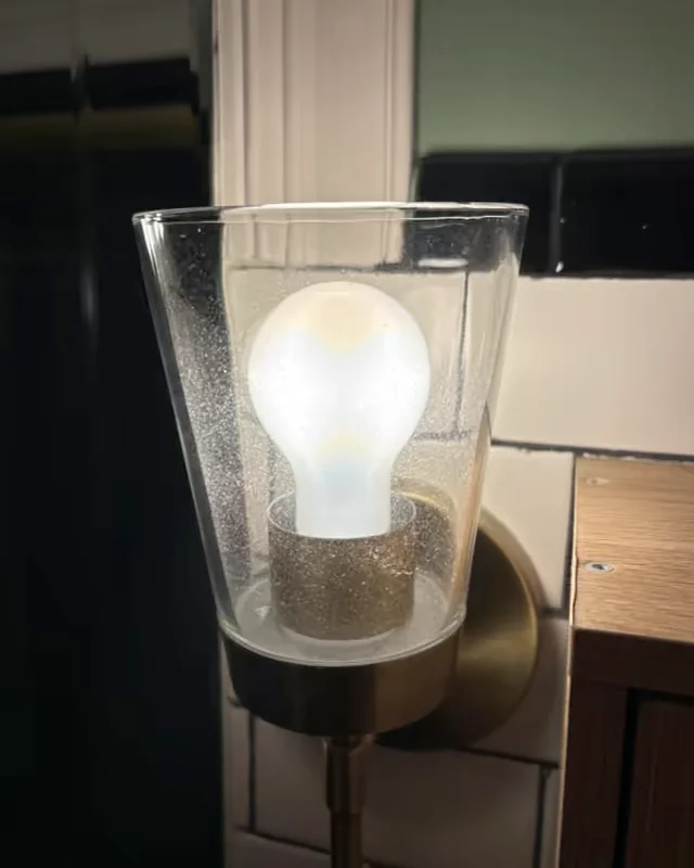 Before: a glass sconce shade speckled with dust and residue.
