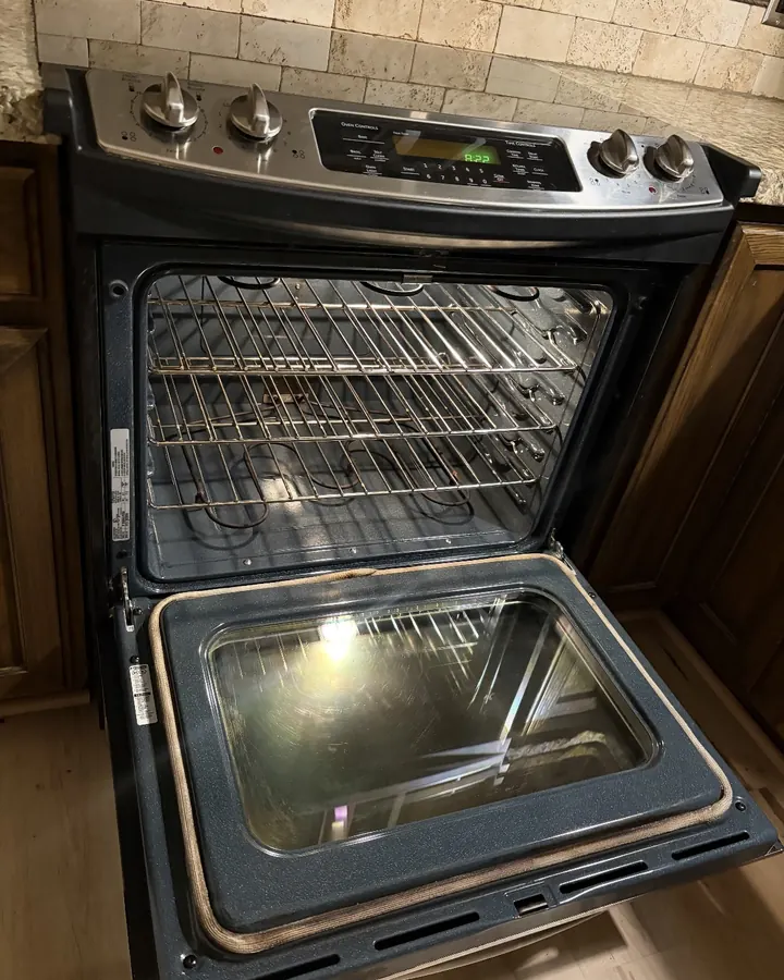 After: the same oven with clear glass and clean racks.
