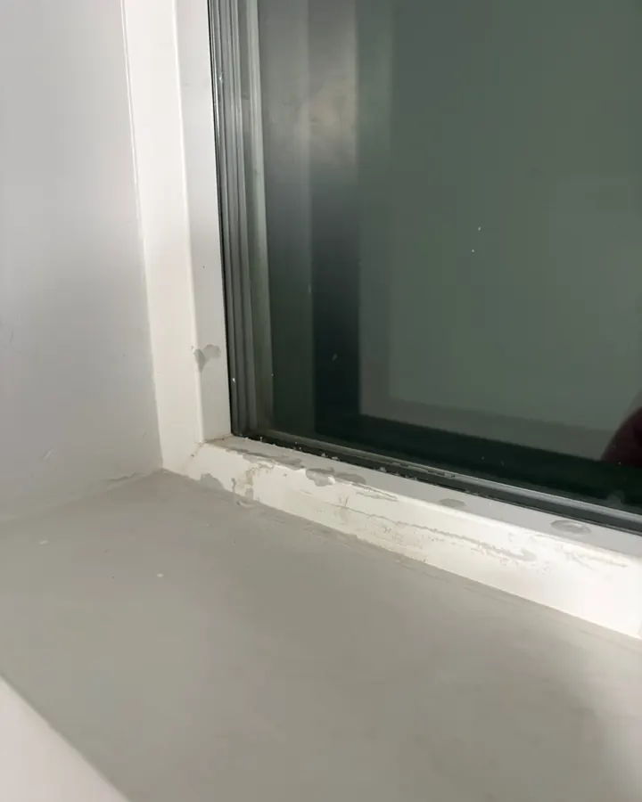Before: paint residue along the bottom edge of a window frame.