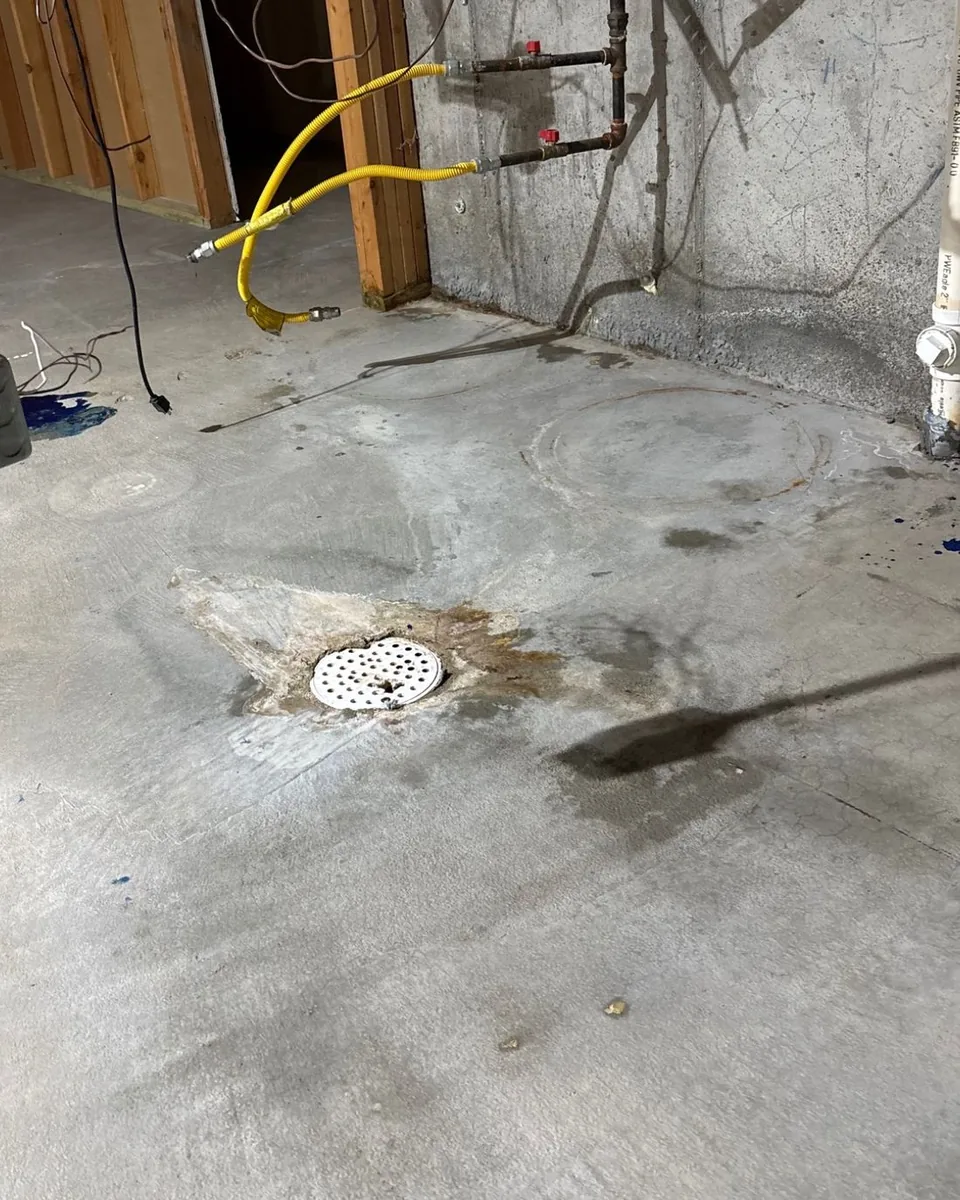 After: the same concrete floor, clean and even around the drain.