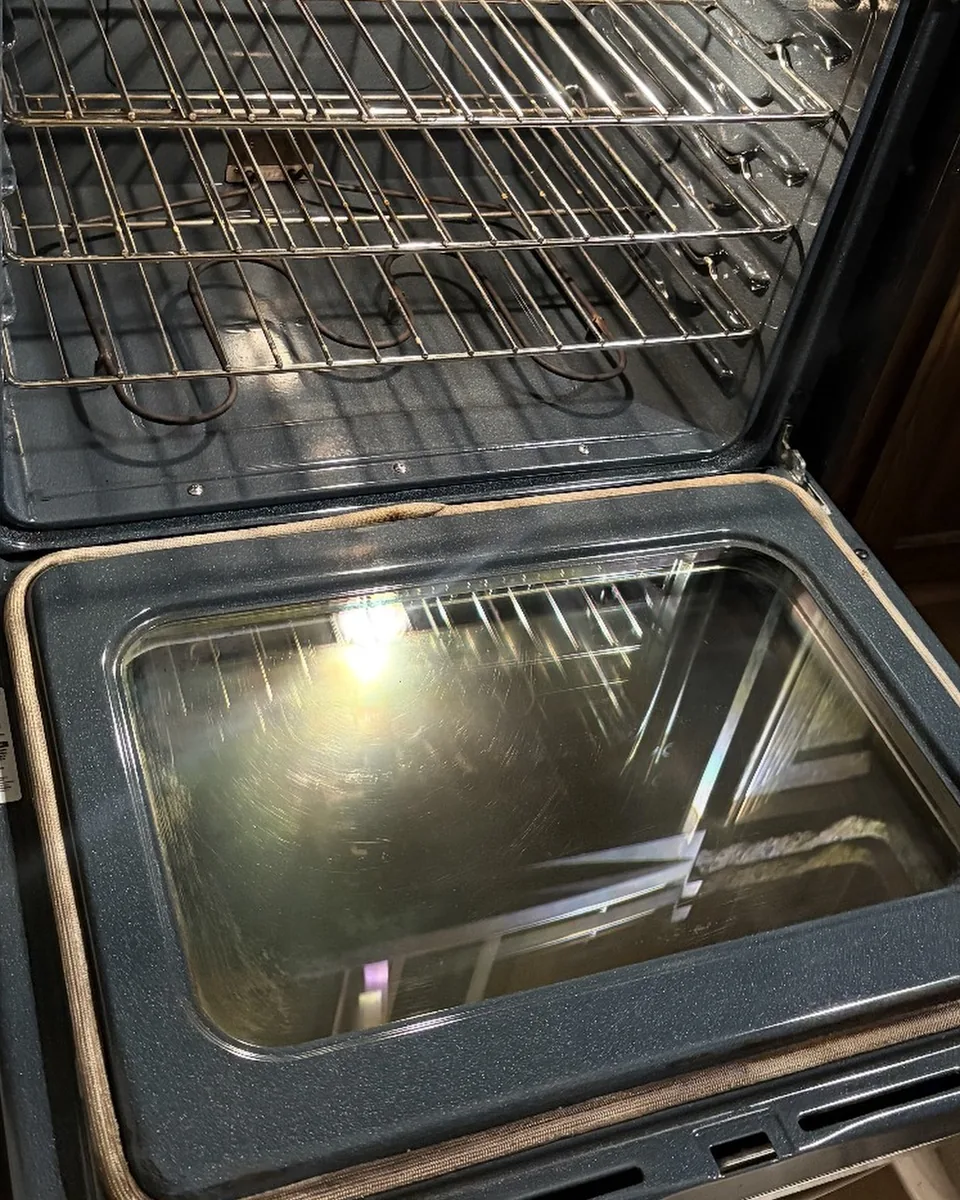 After: the same oven with clear door glass and bright racks.